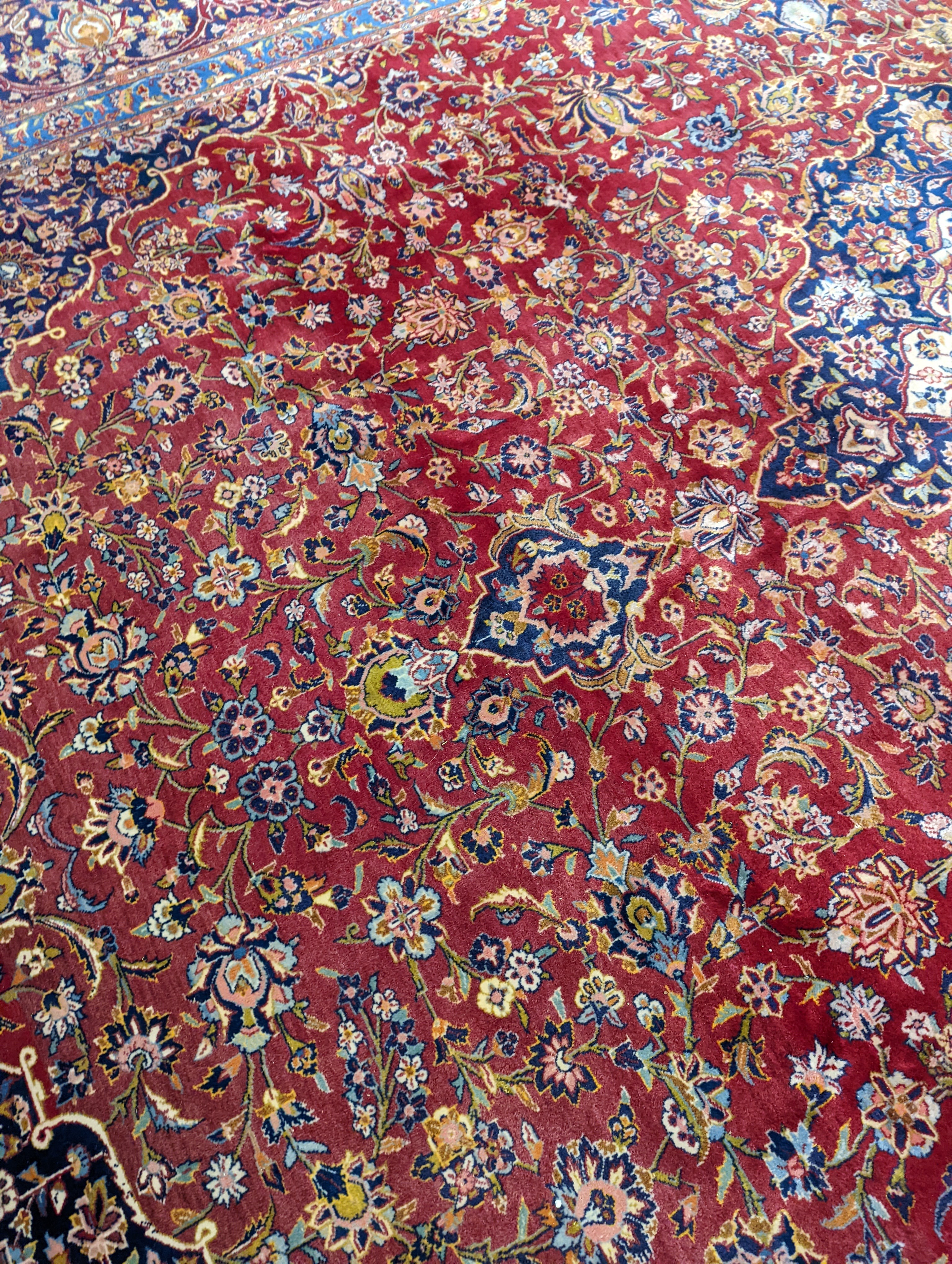 A large Tabriz red ground floral carpet, 540 x 350cm